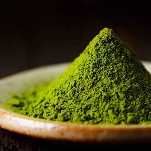 Ingredient: Green Tea in powder in a wooden bowl.