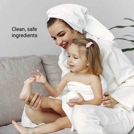 Image of mother and daughter applying cream on daughter's toe.