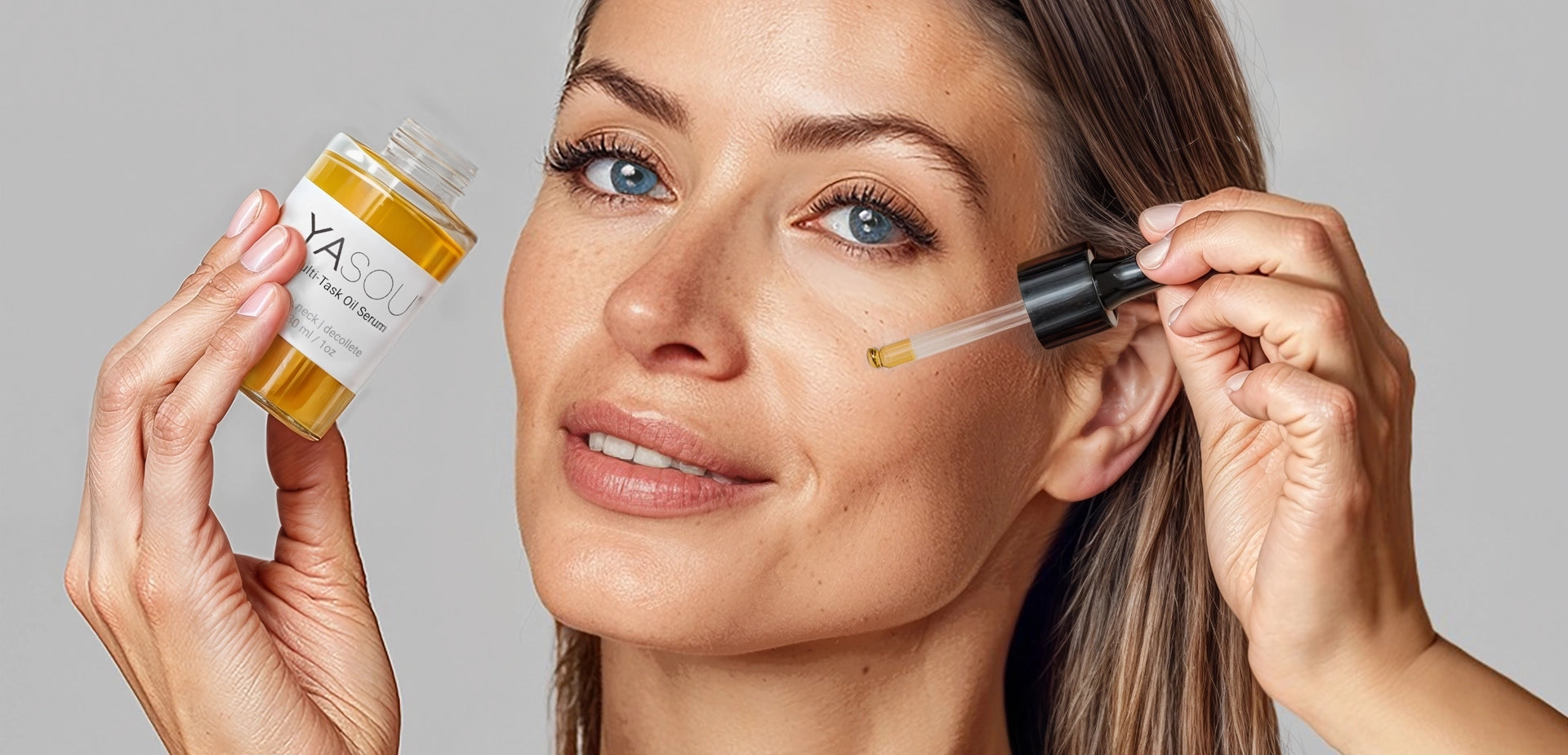 Hero image close up of an attractive woman with blue eyes applying YASOU's vegan multi-task oil serum.