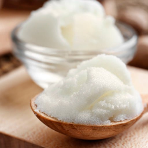 Ingredient: Shea Butter in a wooden spoon.