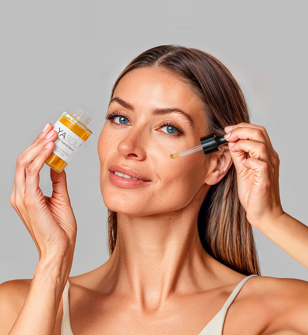 Woman with healthy, glowing skin trying YASOU's Multi-Task Oil Serum. She has light brown hair and blue eyes.