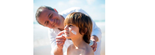 Man putting sunscreen on son's face. Image is for YASOU's blog post called "10 Natural Sunscreens For Summer".