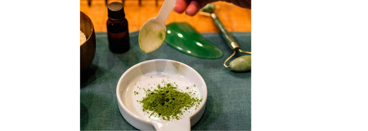 Small white dish with wood spoon pouring green tea in it for YASOU blog post called "Ayurvedic Skin Care Wisdom for Your Skin".