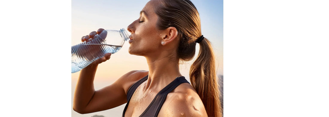 Exercise & Skin Health blog post image of sweaty woman who seems to have been exercising, taking a break to drink some water