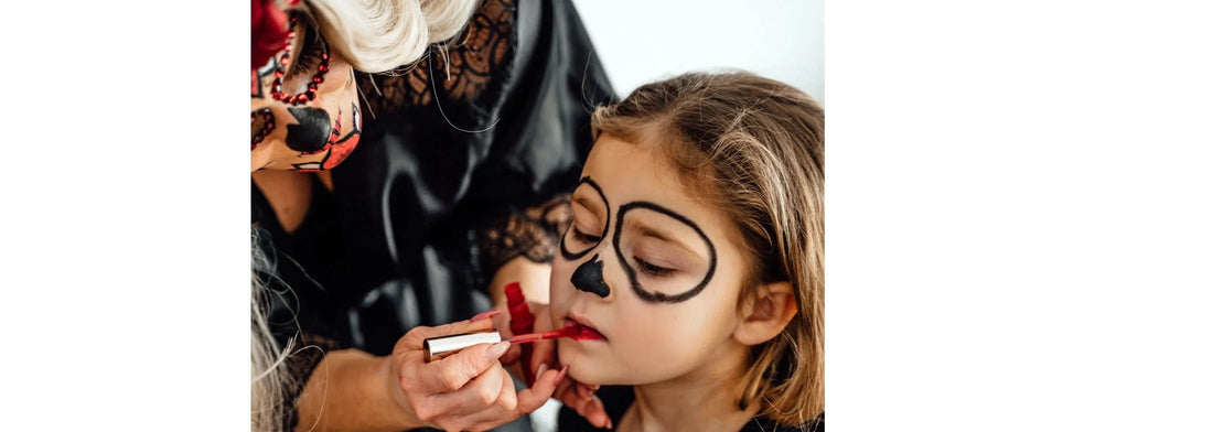 Mother putting on natural halloween makeup on little girl for Halloween. For YASOU blog post called "Natural Halloween Makeup