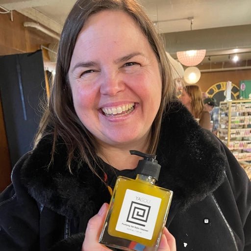 Happy customer holding a bottle of soap with a brand logo in an indoor setting