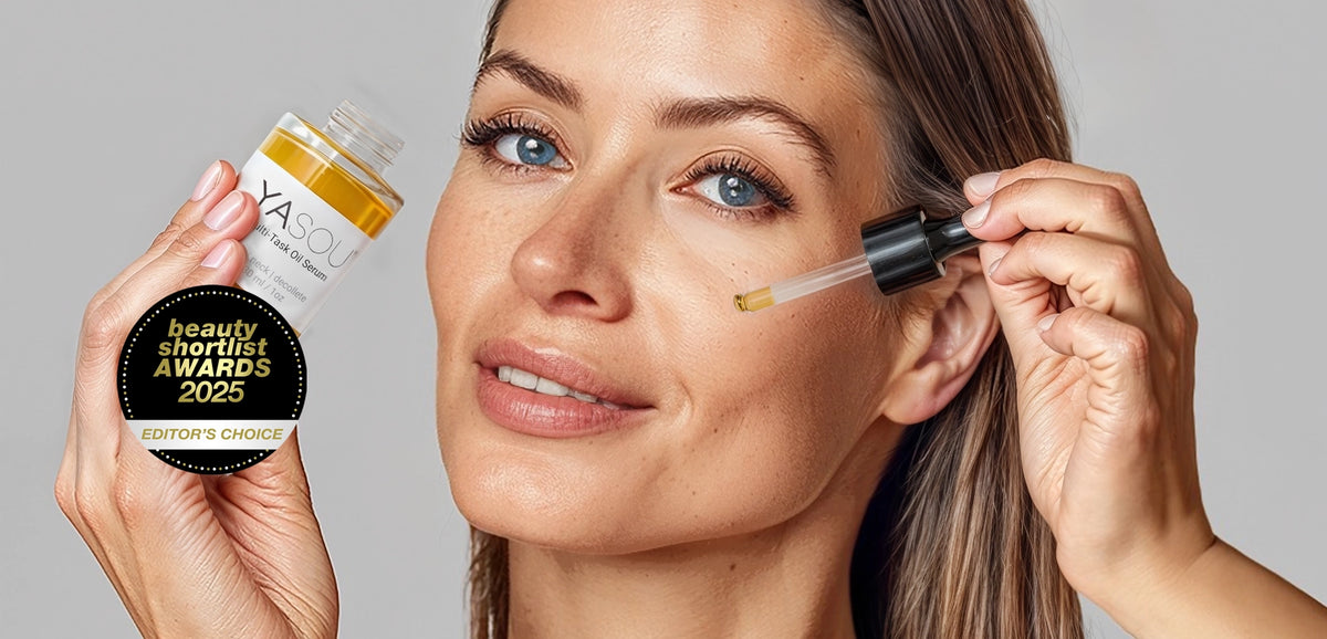 Hero image close up of an attractive woman with blue eyes applying YASOU's vegan multi-task oil serum with the Beuty Shortlist Awards 2025 button.