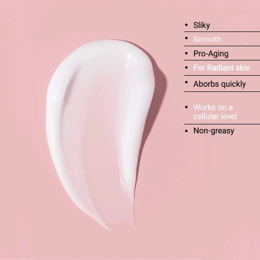 White skincare product smear on a pink background with text describing its properties.